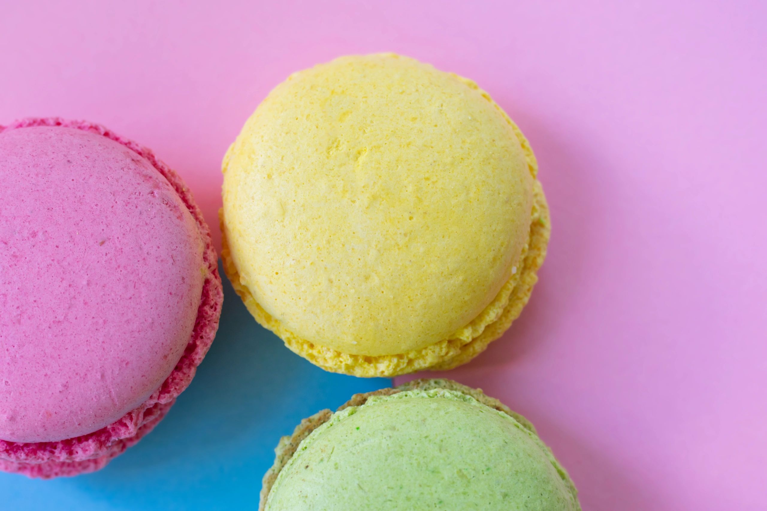 Traditional French macarons in pastel colors on a styled background